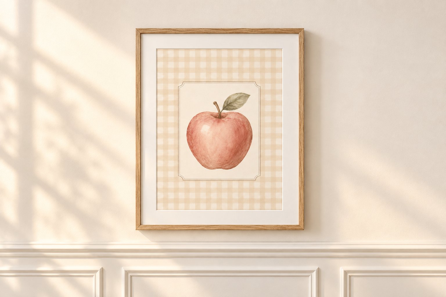 The Cottage Schoolroom watercolor apple printable in a thin vintage oak frame on a cream-painted wainscoted wall in warm amber late-afternoon light with soft mullioned window shadows.